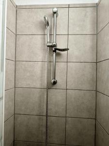 y baño con ducha y pared de azulejos. en Heart of Las Americas Charming Beach Apartment Tenerife, en Costa de Adeje