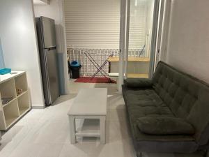 a living room with a couch and a table at Studio Turkoise in Saint-François +1 photo
