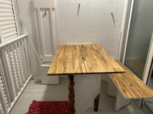 a wooden table in a room with a staircase at Studio Turkoise in Saint-François