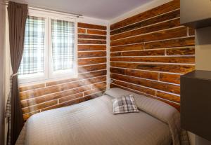 A bed or beds in a room at Camping Camplani