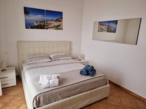 a bedroom with a bed with two pictures on the wall at PHS Panoramic House Suite in Taormina