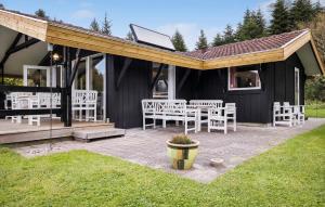 a pavilion with white chairs and tables on a patio at Lovely Home In Fjerritslev With Wifi in Fjerritslev +12 photos