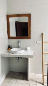 a bathroom with a sink and a mirror at Bingin Family Bungalow in Uluwatu +15 photos