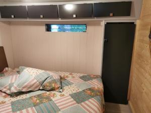 a bedroom with a bed and a window and a door at Chalet Paradise Cottage in Hastière-par-delà