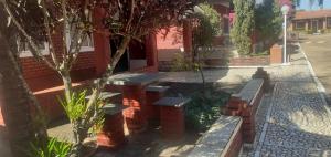 a group of benches in front of a building at Chalé jane in Caldas Novas