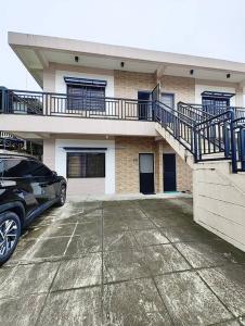 a car parked in a parking lot in front of a building at Jet01- Modern Unit in Pampanga Near Clark with Parking in Angeles
