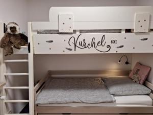 a white bunk bed in a room with a ladder at Ferienwohnung Allgäuerle 1605 Ski in Ski out an der Skipiste mit Hallenbad Sauna und Tiefgarage in Missen-Wilhams