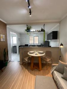 a living room with a table and a couch at Flórida vivo bem! in São Roque