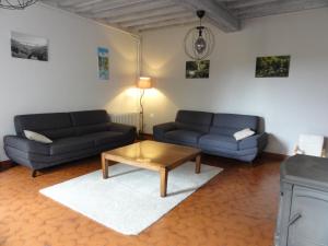 a living room with two couches and a coffee table at Bienvenue chez Fanny in Bussières