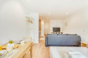 a living room with a bed and a table at Blue Charm - Campolide Apartments in Lisbon