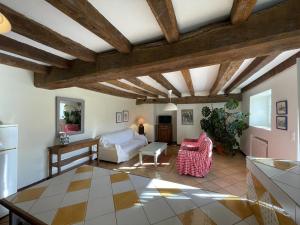 a living room with wooden ceilings and a table at Ferme uhartea in Sare