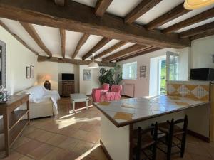 a kitchen and living room with a table and chairs at Ferme uhartea in Sare +19 photos