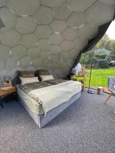 a bedroom with a large bed in a tent at Paradiesufer am See in Milmersdorf