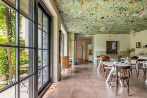a dining room with a ceiling with fish painted on it at Hotel Elvezia in Cannobio
