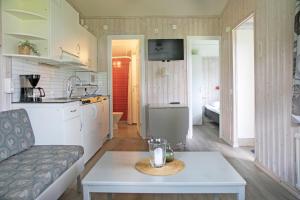 a kitchen and living room with a table and a couch at Kvibergs Stugor - Cottages in Gothenburg