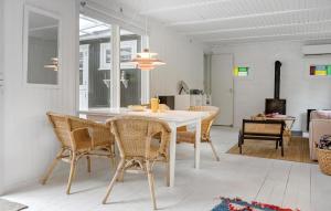 a dining room with a white table and chairs at 4 Bedroom Cozy Home In Vejby in Vejby