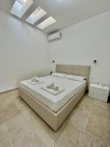 Ένα ή περισσότερα κρεβάτια σε δωμάτιο στο Il Villino Porto Cesareo - Alloggio con posto auto