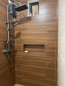a bathroom with a shower with a wooden wall at MANEL Guest House - Donsol, Philippines in Donsol +208 photos