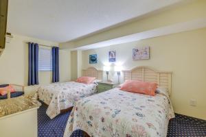 a hotel room with two beds and a window at 2 Mi to Barefoot Landing Condo with Beach Access! in Myrtle Beach +26 photos