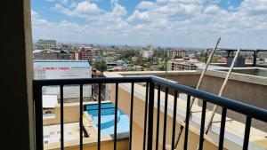 a balcony with a view of a city at Well Furnished Studio Apartment at Kamakis Opposite Quickmart in Ruiru