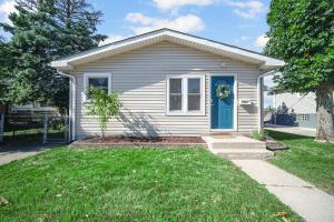a small white house with a blue door at Cozy Private Room in Hammond, IN - 2 in Hammond