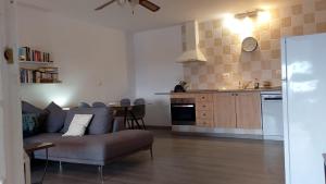 a living room with a couch and a kitchen at Villa Tranquilla in Estepona