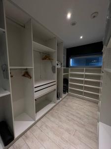 a walk in closet with white cabinets and a window at Luxuriöse Penthousewohnung in der Quakenbrücker Altstadt in Quakenbrück