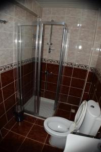a bathroom with a shower and a toilet at VİLLA KEYF in Side