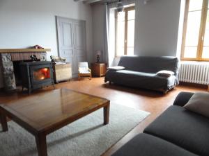 a living room with a couch and a coffee table at Bienvenue chez Fanny in Bussières