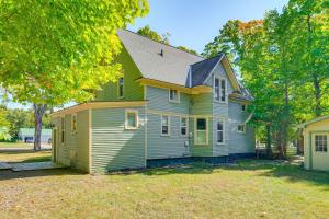 a green and yellow house with a yard at Near Lake Historic Boyne City Home with Fire Pit! in Boyne City
