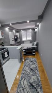 a living room with a couch and a rug at Apartman Hram Zvornik in Zvornik