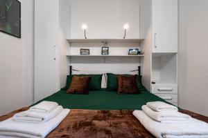 a bedroom with a green bed with three pillows at Roma centro pochi minuti - Appartamento con giardino privato in Rome
