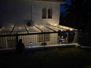 a person sitting in front of a fence at night at Villa Tranquilla in Estepona