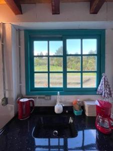 a kitchen with a sink and a window at Reserva Pedra da Mata in Pelotas