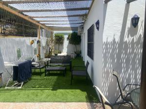 a patio with chairs and tables and awning at Villa Tranquilla in Estepona