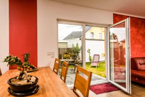 a dining room with a sliding glass door leading to a patio at Spreewaldferienhäuser am Deich in Lübben
