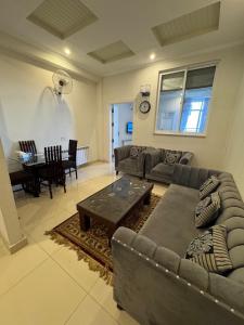 a living room with a couch and a table at Serenity Suites in Bhurban