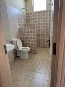 a bathroom with a toilet and a sink at Serenity Suites in Bhurban +19 photos