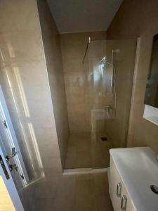 a bathroom with a shower and a toilet and a sink at SeaCharm in Dobra Voda +12 photos