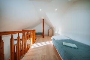 a bedroom with a bed and a staircase at Apartmány Reduta in Lučenec