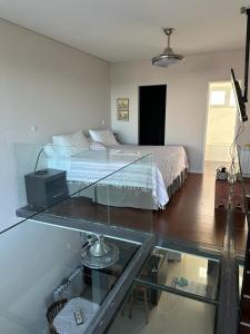 a bedroom with a bed and a glass table at Ayres del Sur in Puerto Madryn