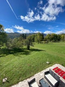 an aerial view of a field with a couch and chairs at Brvnara Bajka Kolašin in Kolašin +22 photos
