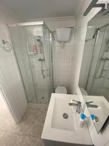 a white bathroom with a shower and a sink at Comfortable Apartment in Viveiro of 100 m² in Viveiro +16 photos