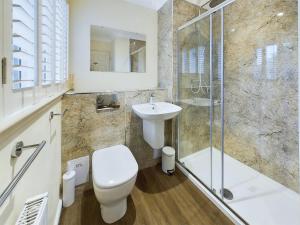 a bathroom with a toilet and a sink and a shower at Rokeby in Bamburgh +10 photos