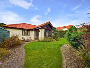 a house with a garden with a pathway at Rokeby in Bamburgh