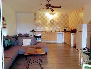 a living room with a couch and a kitchen at Villa Tranquilla in Estepona