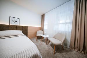 Posteľ alebo postele v izbe v ubytovaní Apartmány Reduta - new