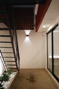 a room with a staircase and a light on the wall at Casa Lomas in Oaxaca City
