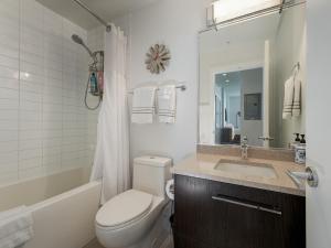 a bathroom with a toilet and a tub and a sink at The Bohemian, min 30-Day Stay with Breathtaking Views and Home Office by Victoria Prime! in Victoria +19 photos