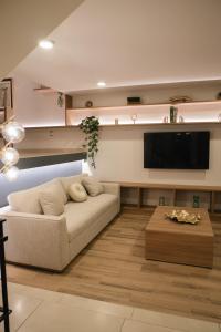 a living room with a couch and a flat screen tv at Casa Lomas in Oaxaca City